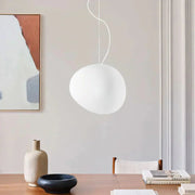 Modern Wabi-Sabi tupel glass pebble pendant light illuminating a minimalist dining table setup
