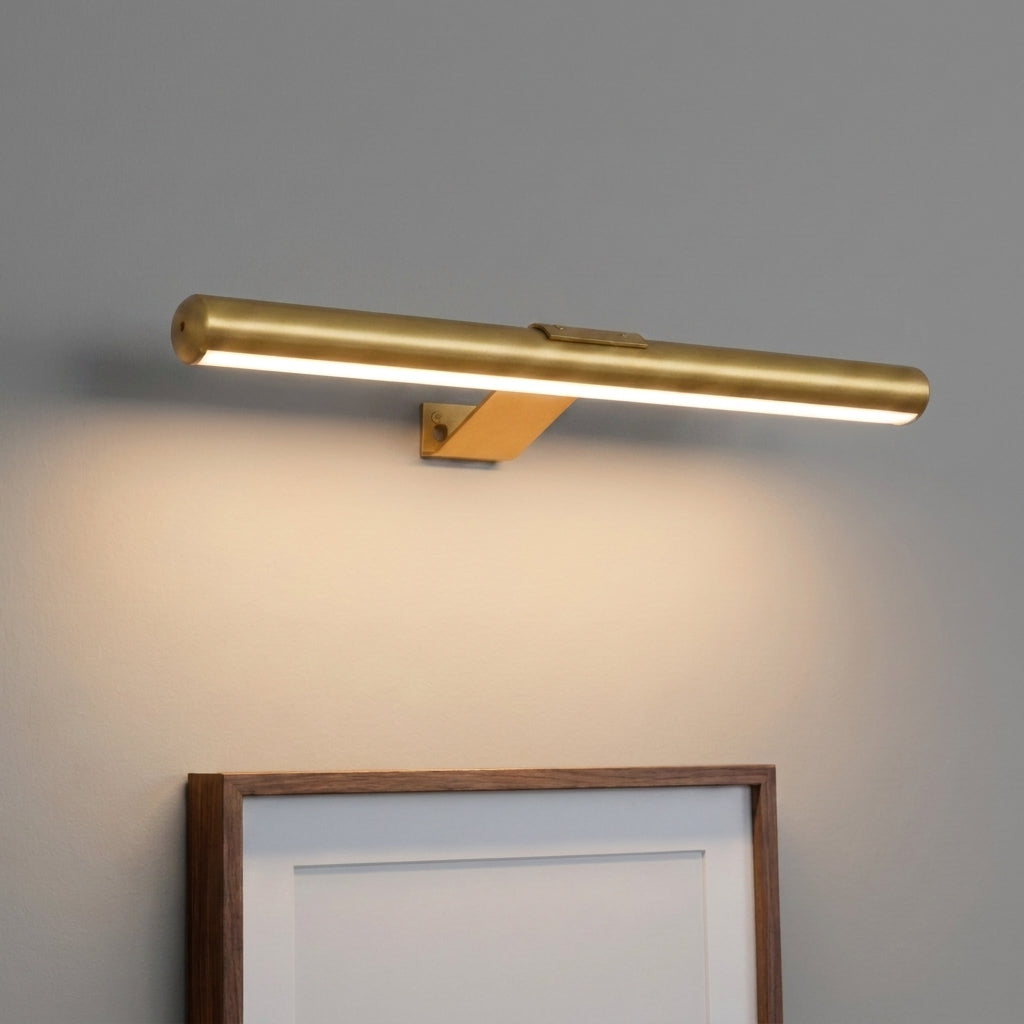 Tuvqi gold wireless LED picture light mounted above a dark wood framed artwork