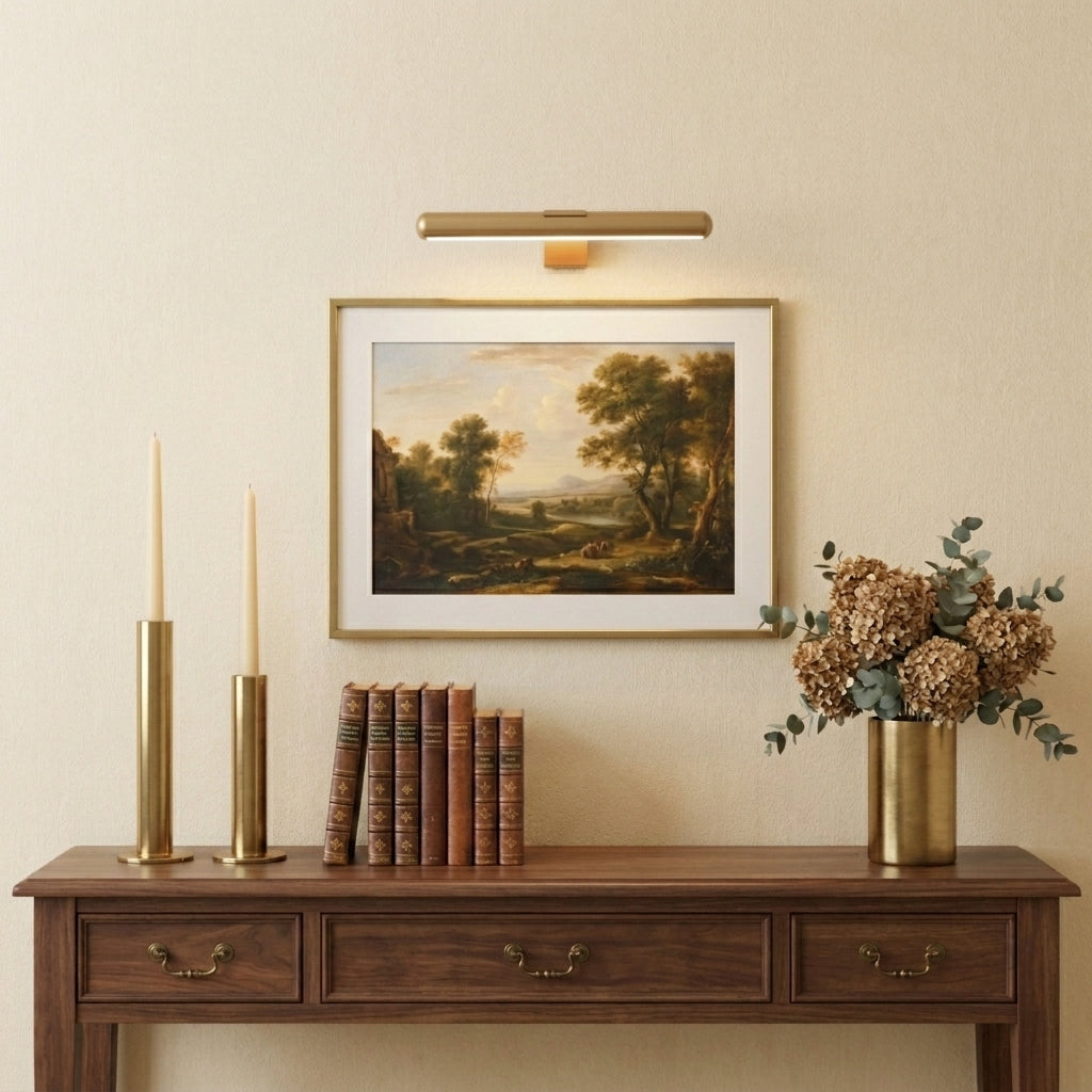 Tuvqi picture light illuminating a landscape painting above a console table display