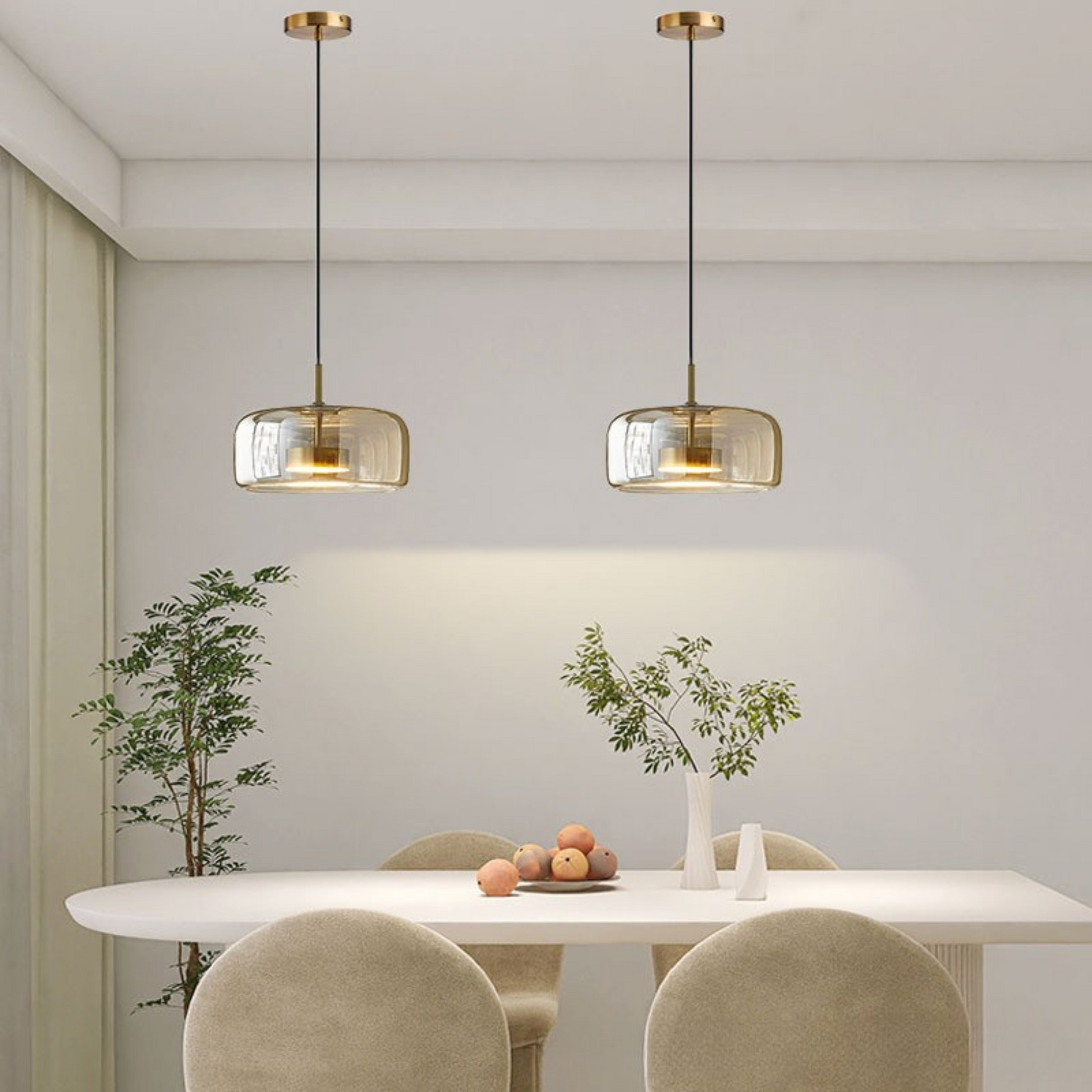 Pair of wide amber glass pendant lights providing warm illumination in a neutral dining room