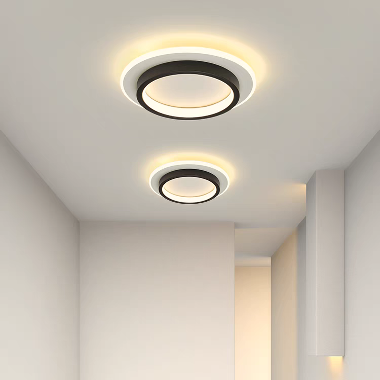 Pair of black geometric LED ceiling lamps providing even illumination in a minimalist interior