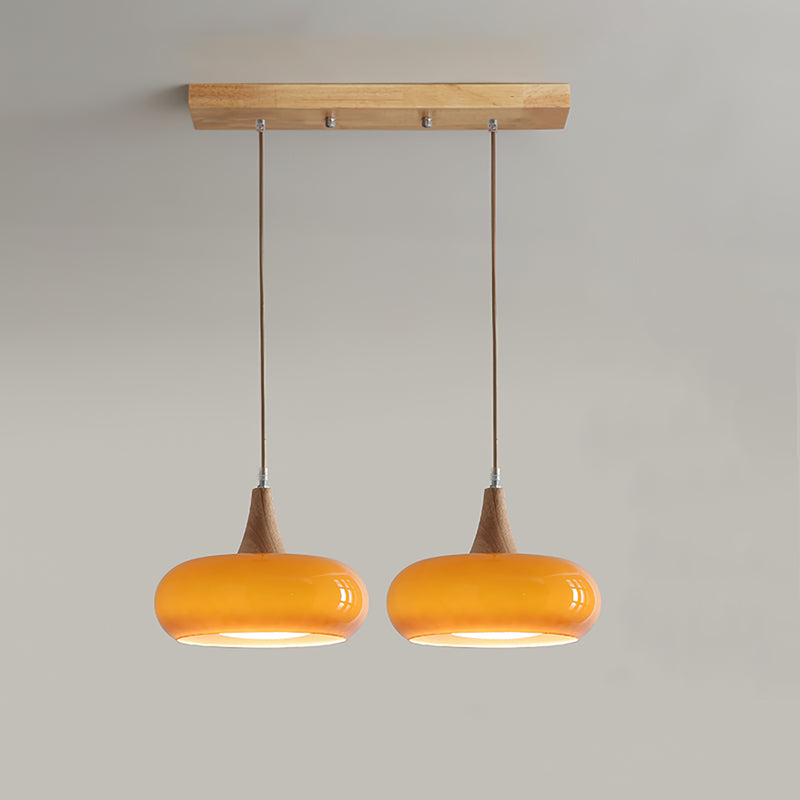 2-head orange linear glass pendant light isolated on a neutral background