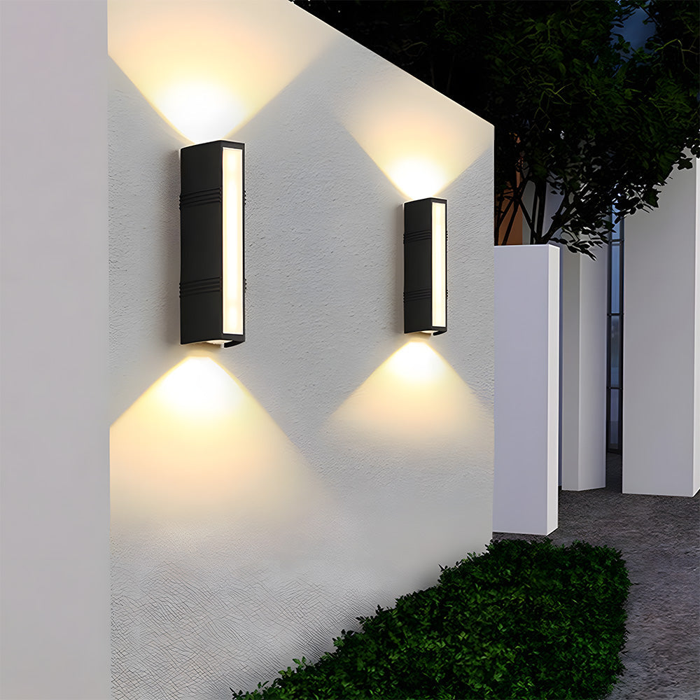 Pair of black linear exterior sconces providing up and down pathway lighting on a modern home
