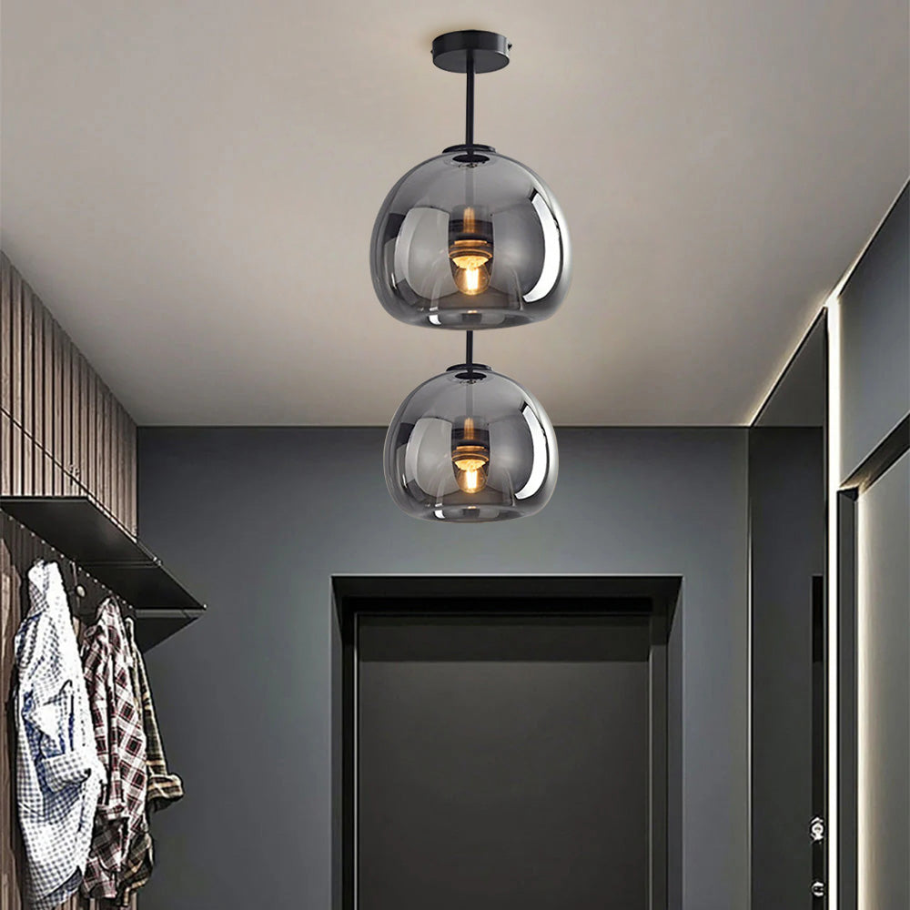 Two tall 29cm smoke grey glass dome flush mount lights illuminating a dark modern corridor