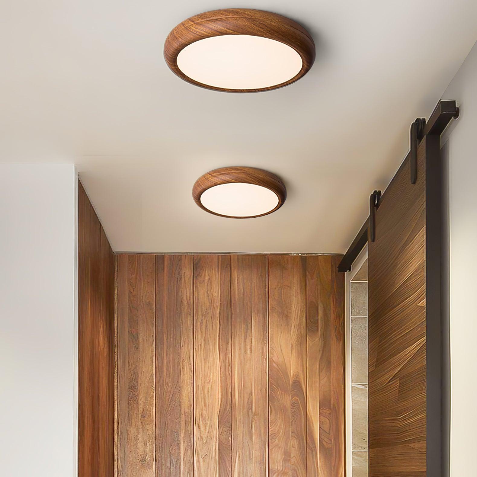Pair of walnut wood-effect flush mount ceiling lights in a contemporary hallway