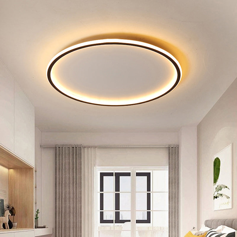 Ultra-thin black halo fixture maintaining a sleek, low profile in a minimalist room