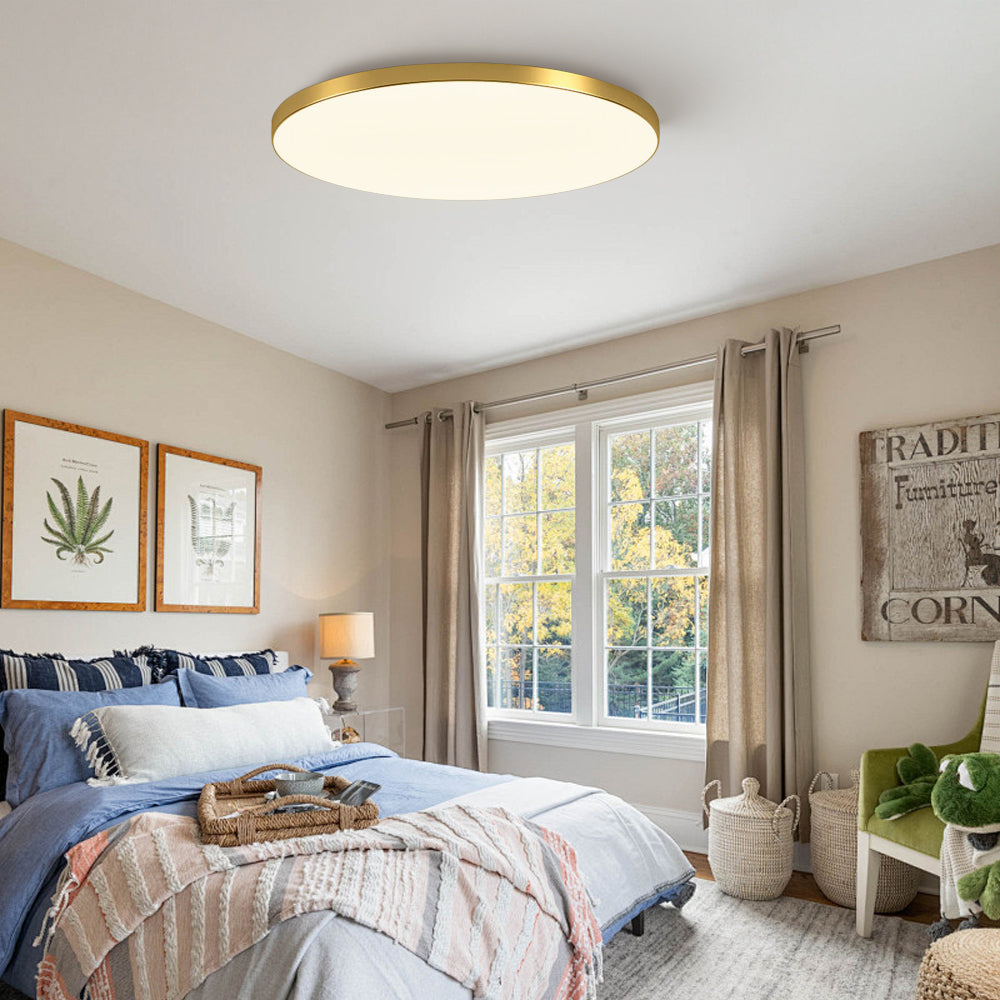 Ultra-thin gold flat panel ceiling light in a bright, modern bedroom
