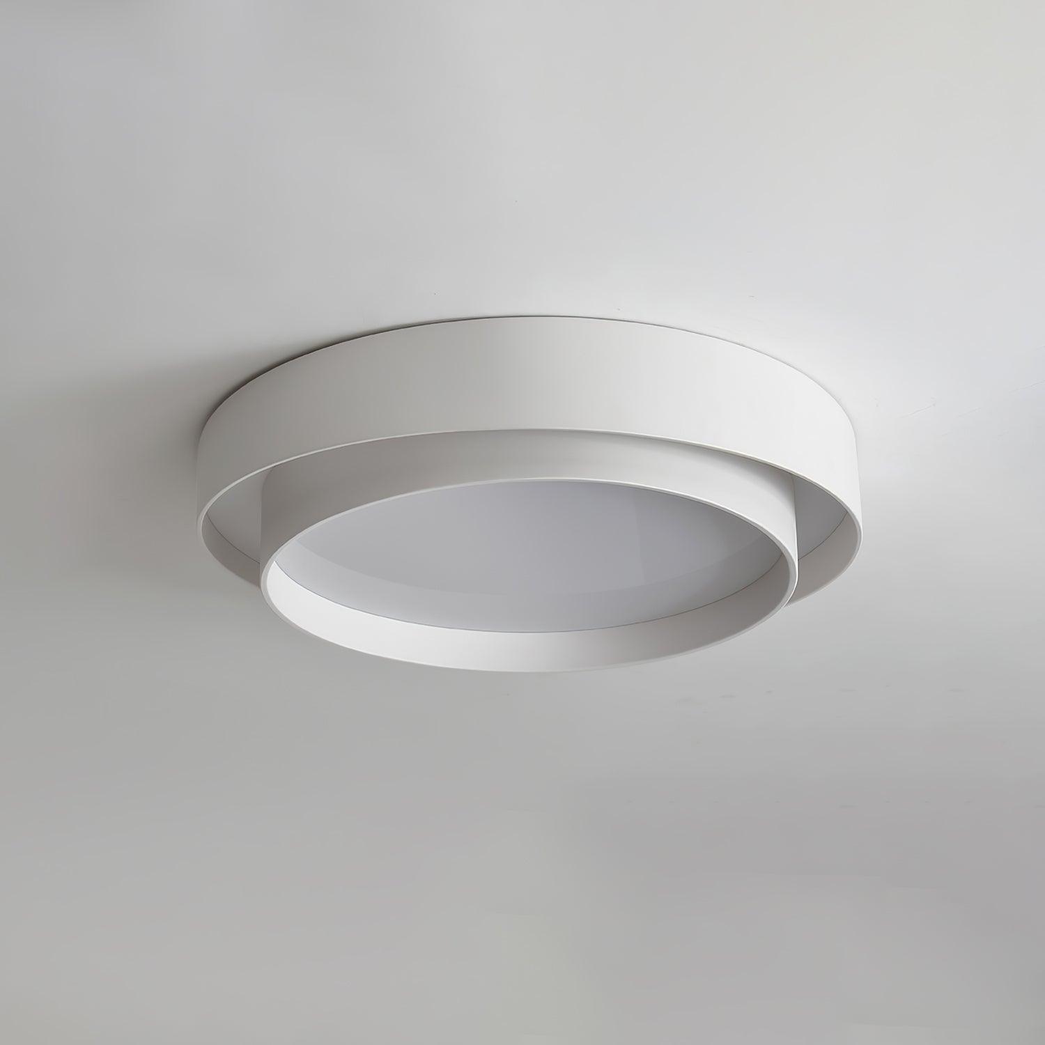 Unlit white double-ring flush mount isolated against a white ceiling, showcasing its ultra-modern silhouette
