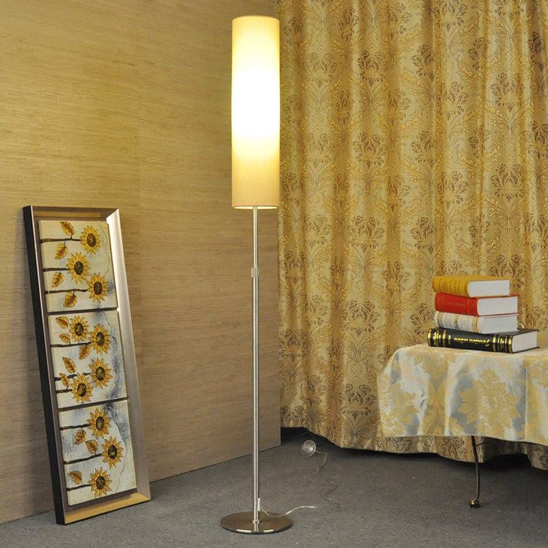 Tall fabric vatel floor light illuminating a cosy corner with patterned curtains and a mirror