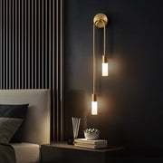 Modern vergs gold U-shaped wall sconce with dual frosted shades acting as an elegant bedside reading light