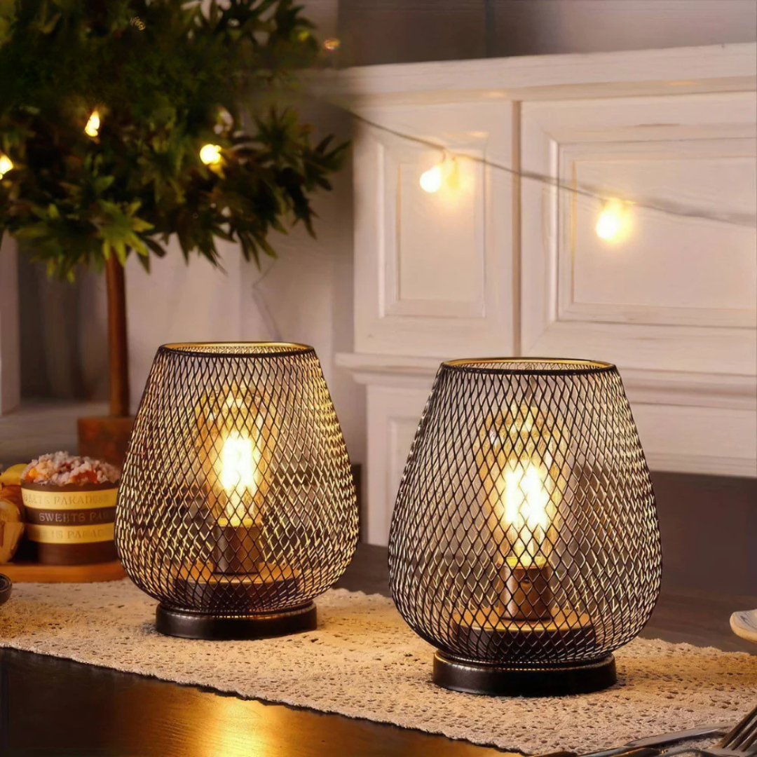 Vintage battery-operated mesh lamps styled on an evening patio table with warm string lights in the background