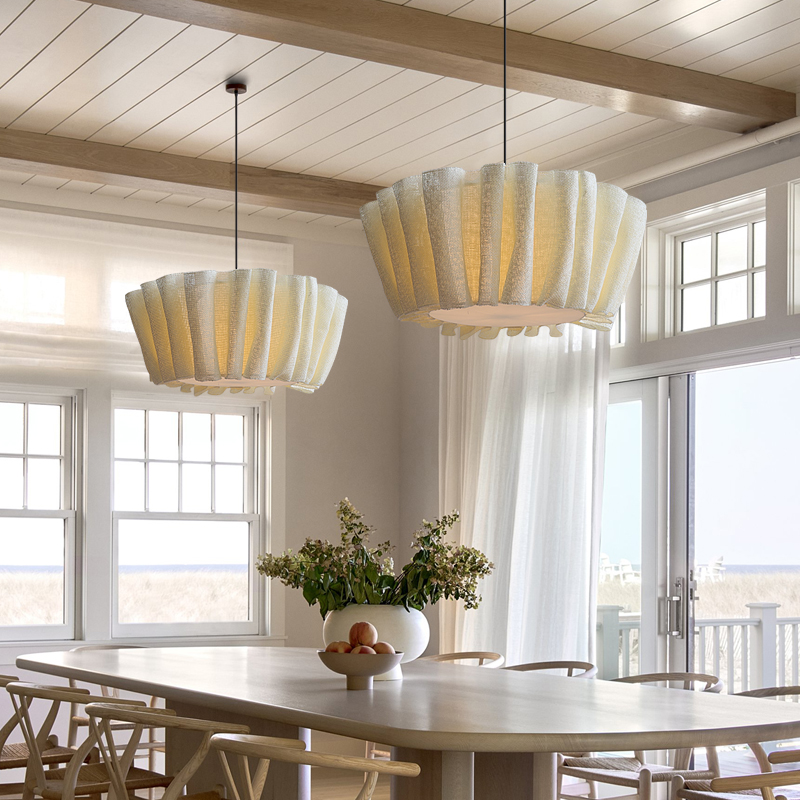 Vintage pleated fabric ceiling lamp casting a warm glow over a bright dining space