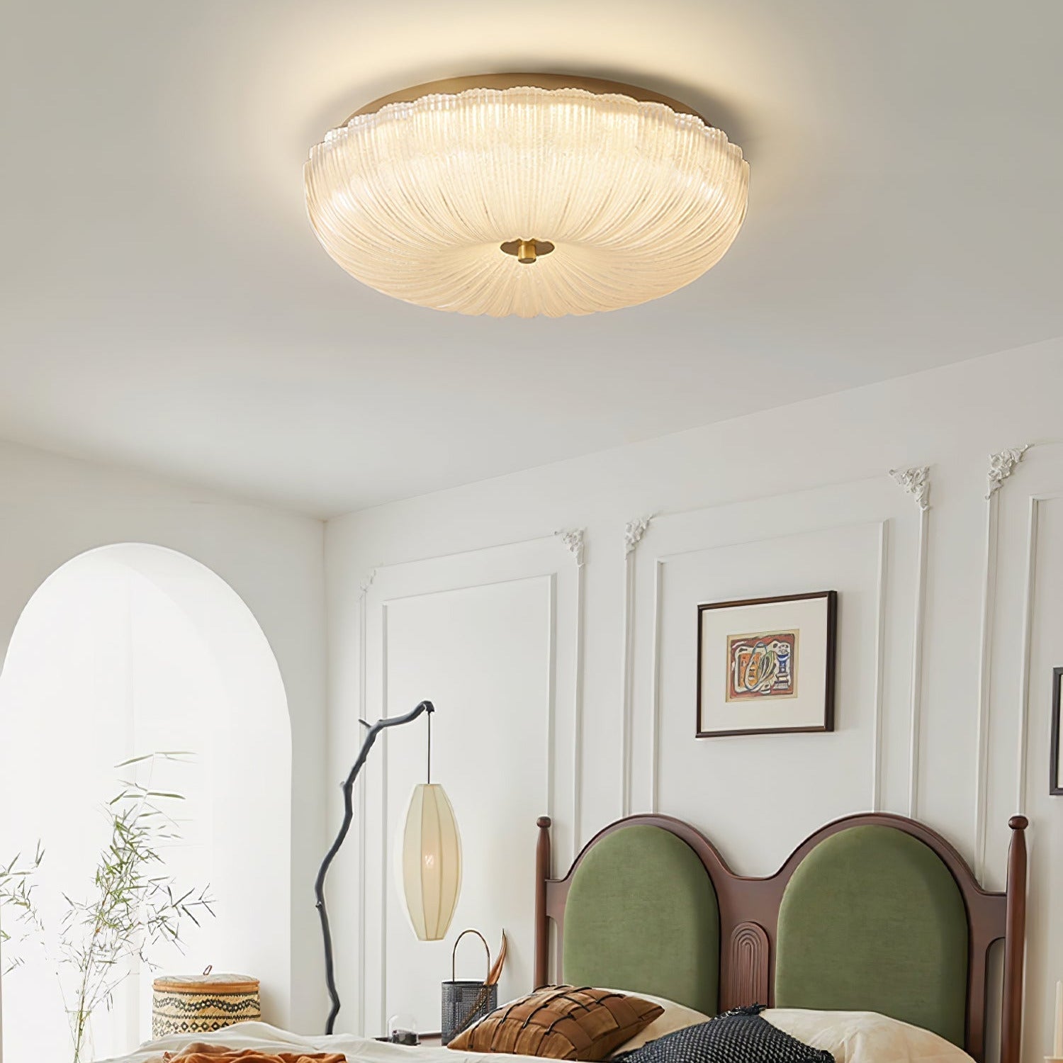 Vintage glass dome ceiling light casting a warm starburst pattern in a bedroom