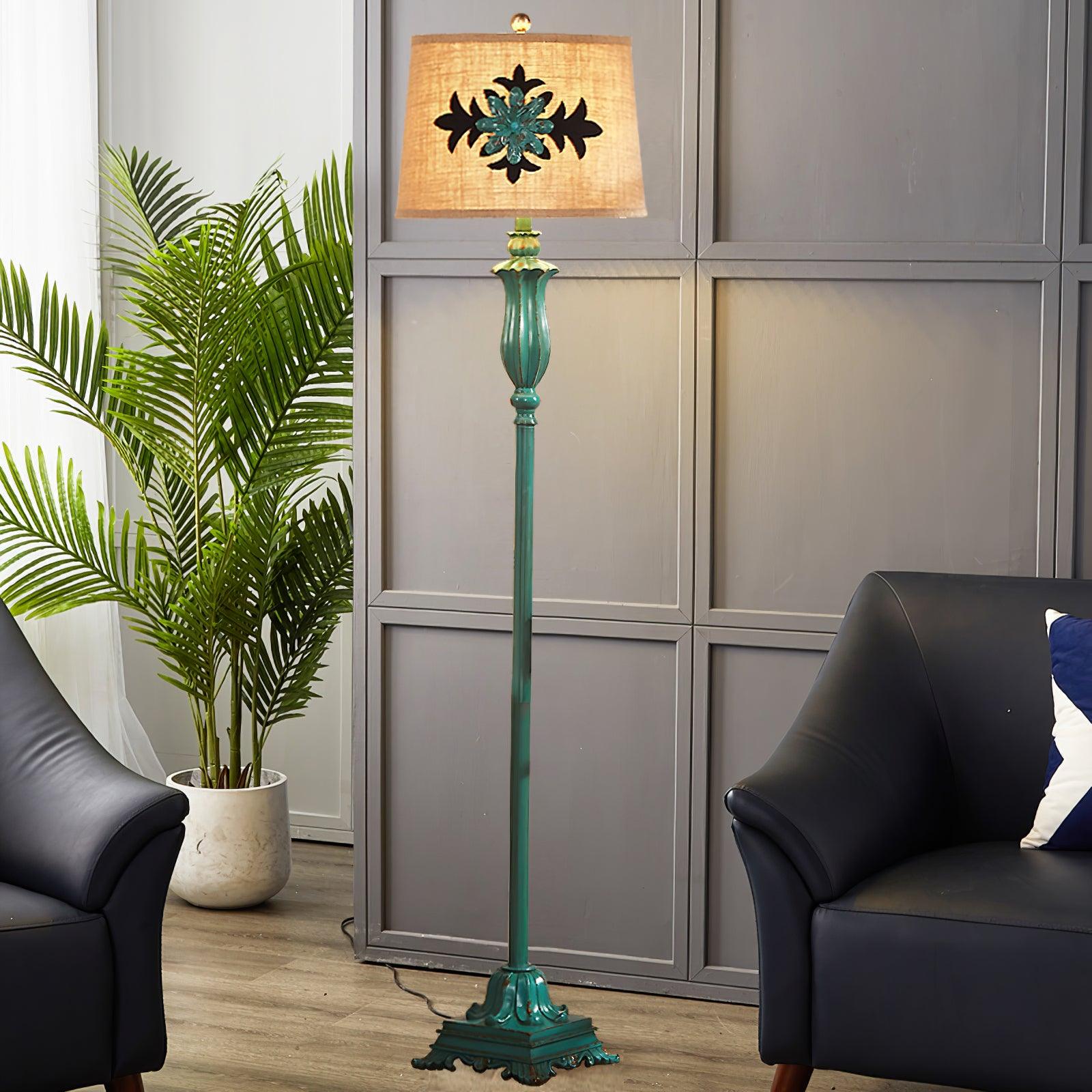 Vintage green resin floor lamp with a patterned fabric shade illuminating a modern living room corner