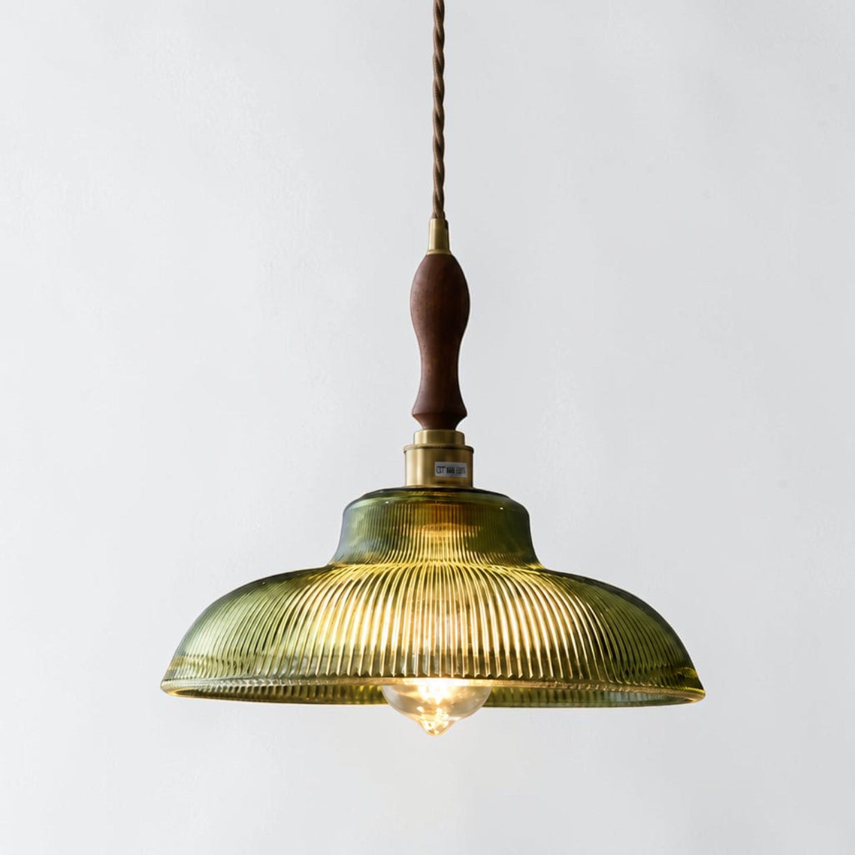 Vopzi single pendant light with wood handle detail on a white background