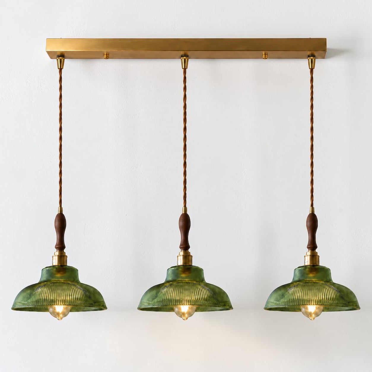 Vopzi 3-Light pendant fixture with brass base, alternate cord finish on a white background