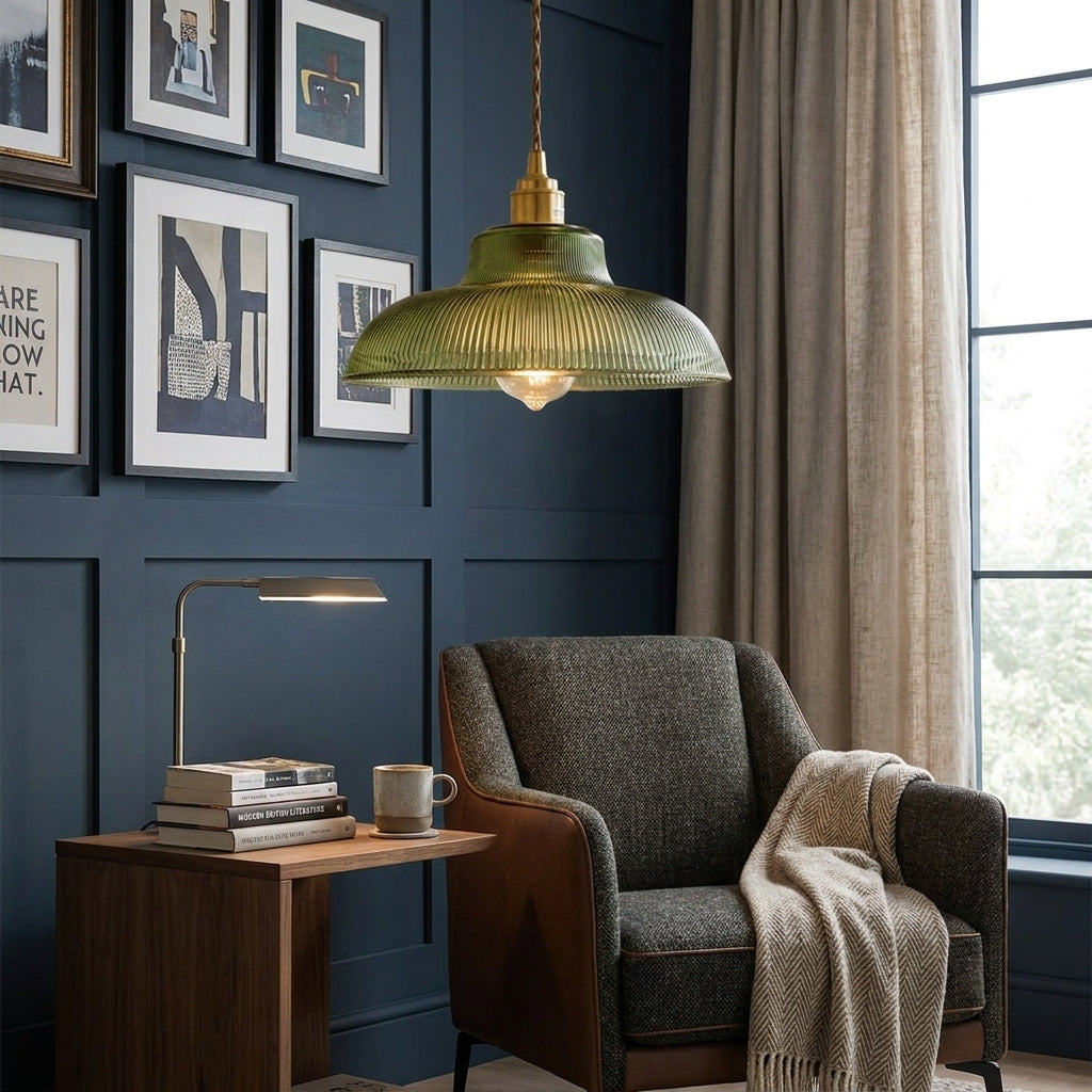 Vopzi pendant light in a dark navy living rooms reading nook with a gallery wall and armchair