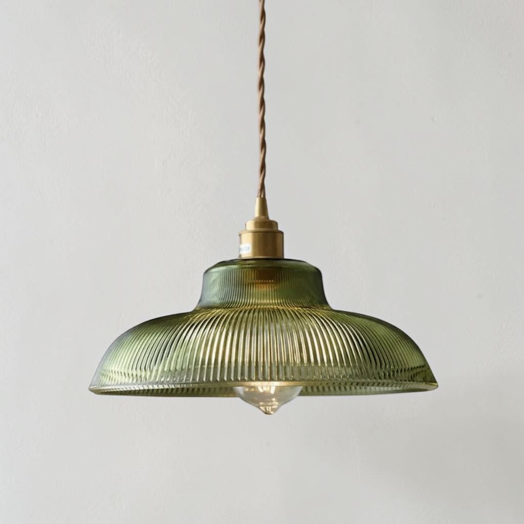 Vopzi green ribbed glass pendant light with brass fitting on a studio grey background