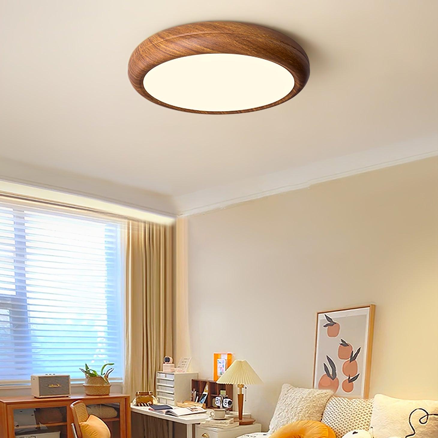 Walnut wood-effect round ceiling light installed in a bright living room