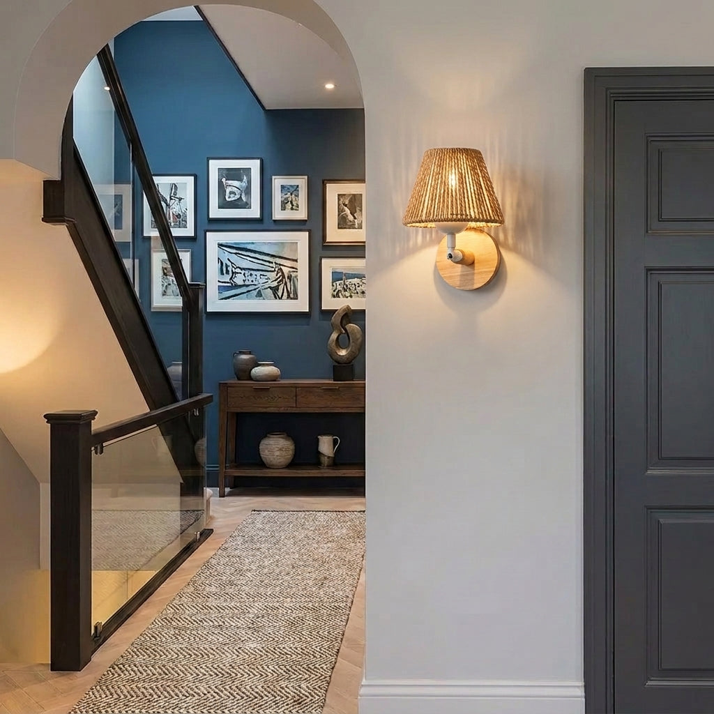 Welsi wood wall sconce mounted in an entryway beside a staircase