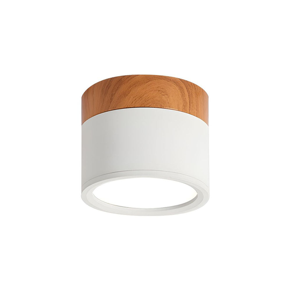 Close-up of a white aluminium cylinder flush ceiling light with natural wood-effect trim