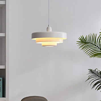 Modern white Bauhaus tiered pendant light hanging in a bright contemporary living space