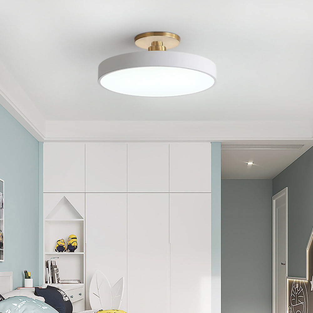 white circular ceiling light providing bright, even illumination in a white walk-in wardrobe.