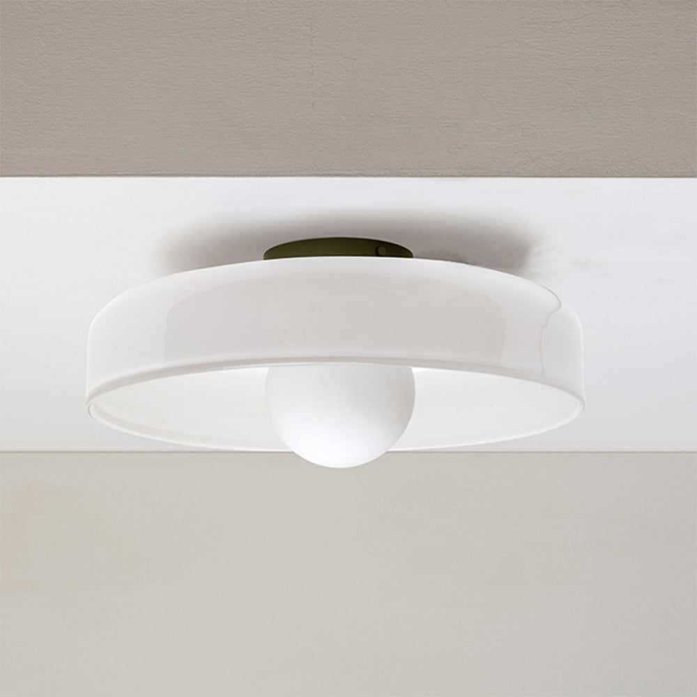 White glass disc ceiling lamp providing clean, minimalist illumination