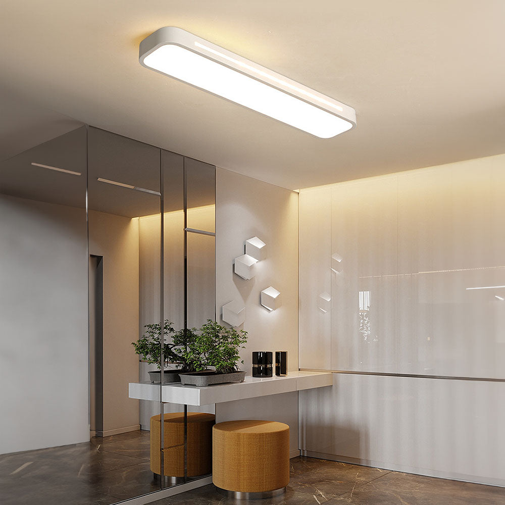 Modern white linear flush mount ceiling light providing bright illumination in a stylish entryway