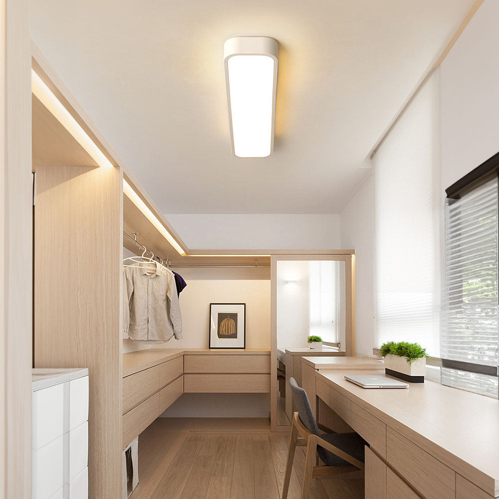 Bright white linear LED flush ceiling light illuminating a modern home office and vanity area