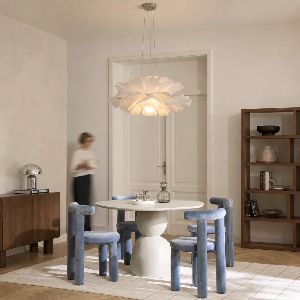 Large white lotus chandelier serving as a stunning focal point over a modern round dining table
