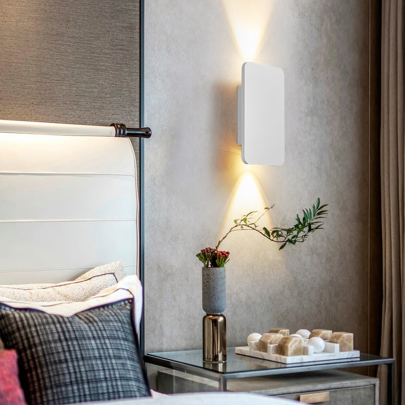 White minimalist rectangular wall lamp acting as a soft ambient bedside light