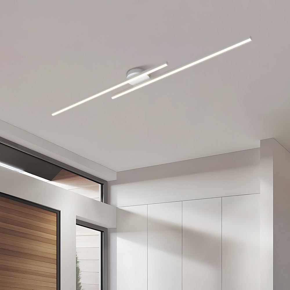 Crisp white staggered linear LED ceiling light glowing warmly in a modern interior