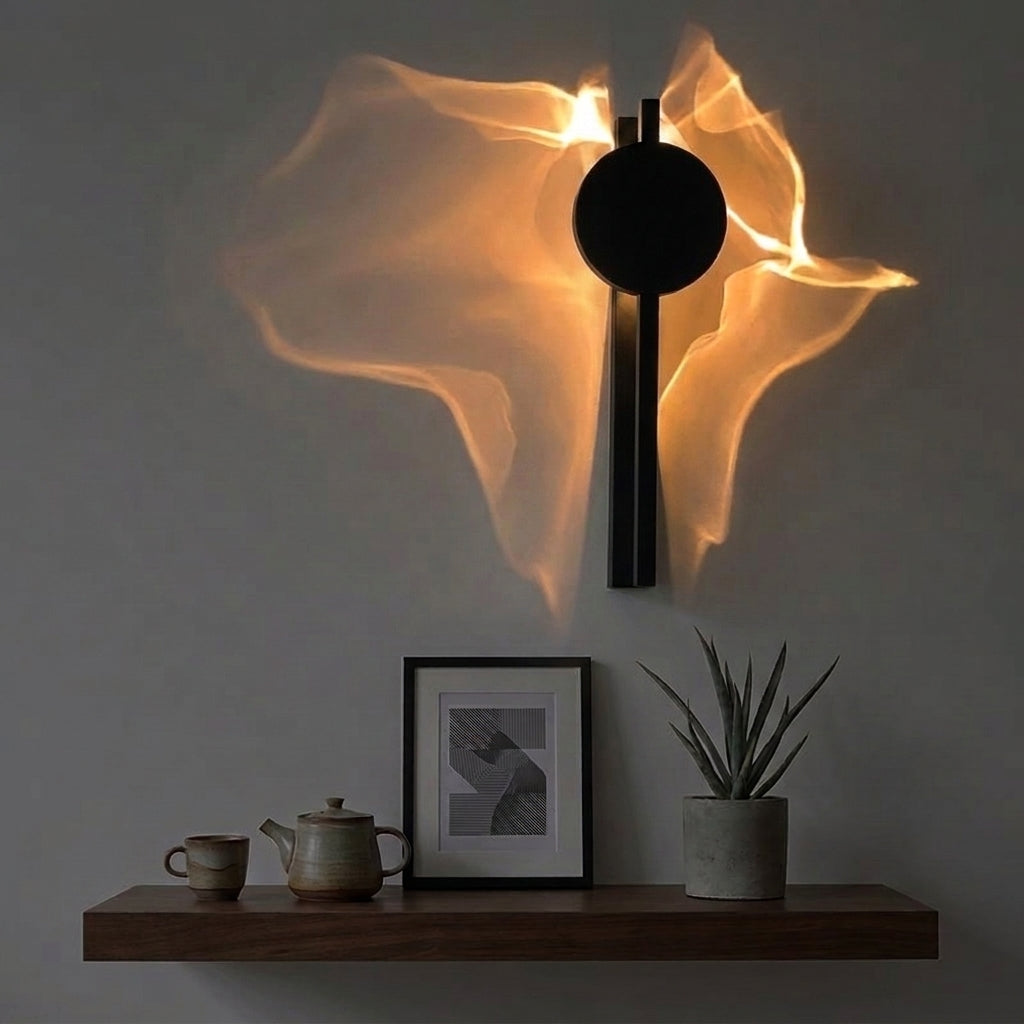 Wobzi black metal ripple wall sconce glowing above a wooden shelf styled with books, a framed print and a plant