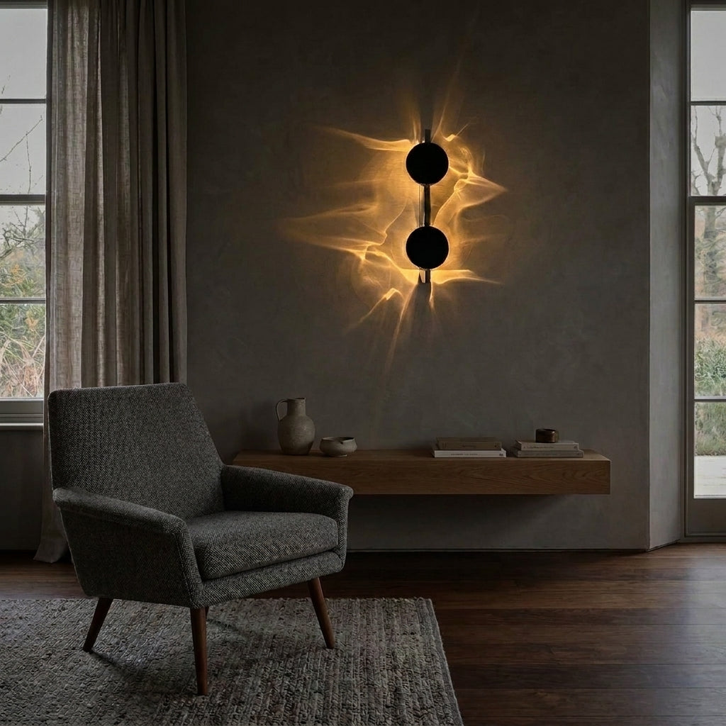 Wobzi Duo wall sconce beside an upholstered armchair and wooden side table with a vase