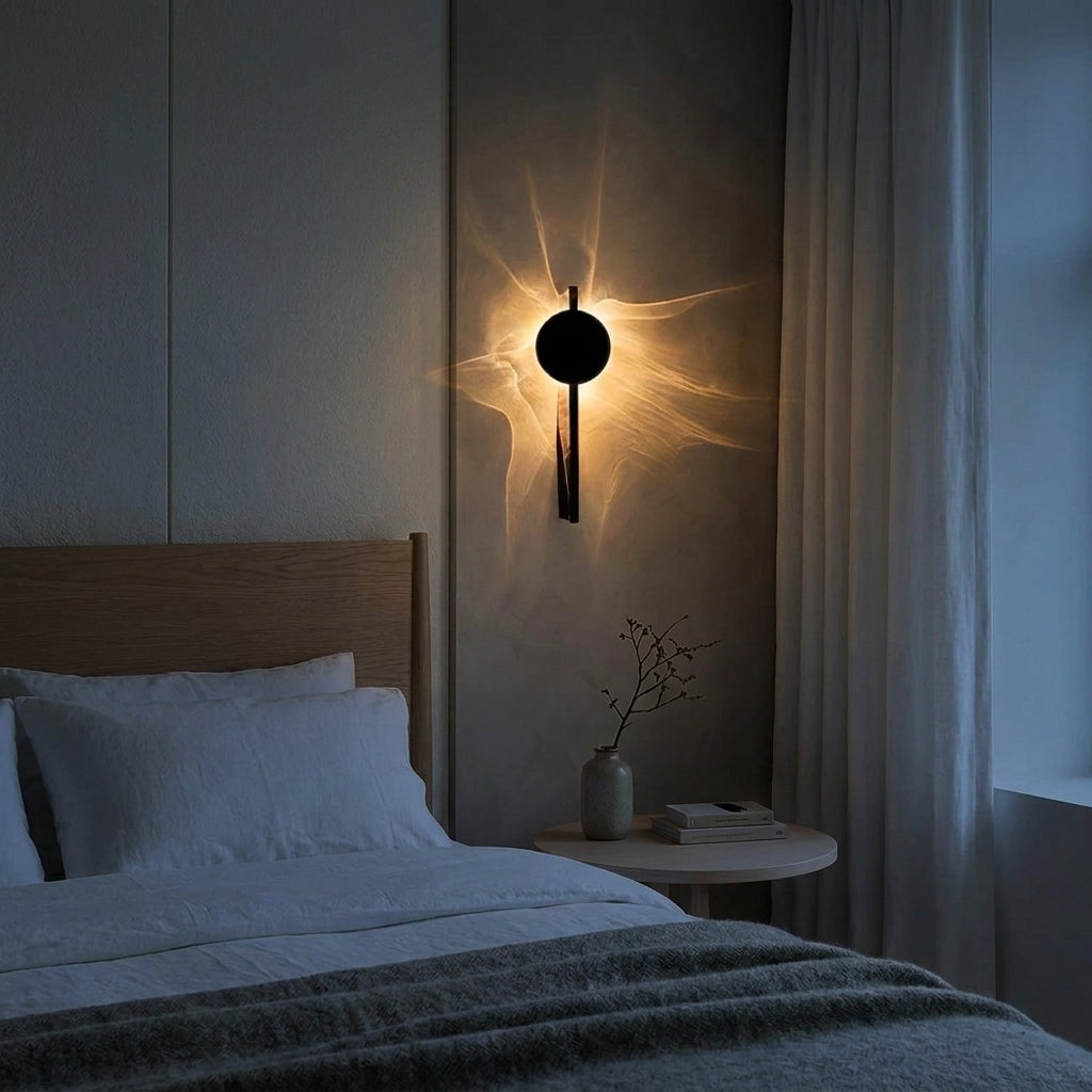 Wobzi wall sconce mounted above a wooden bed headboard in a bedroom with pillows and a side table