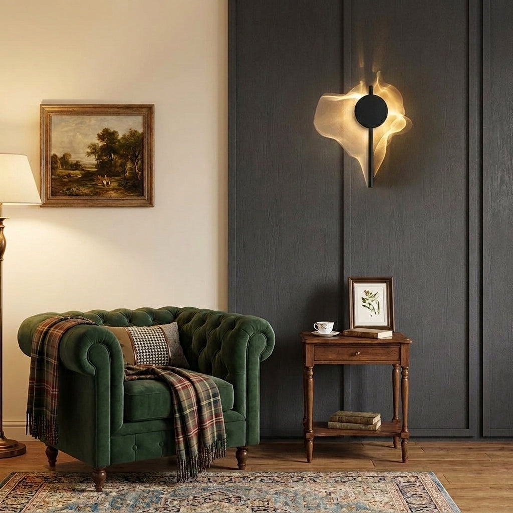 Wobzi wall sconce beside a green tufted chesterfield armchair and vintage side table