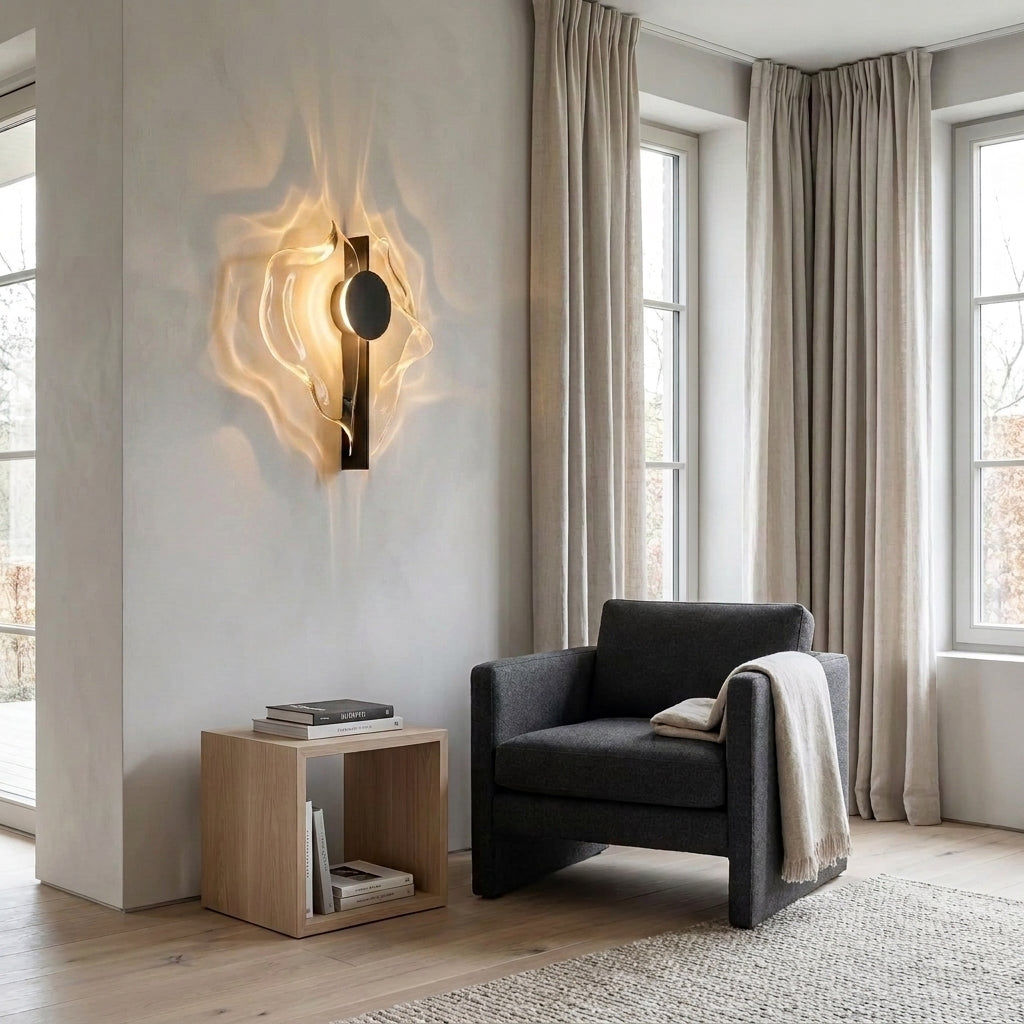 Wobzi wall sconce beside a dark armchair and wooden side table in front of tall curtained windows