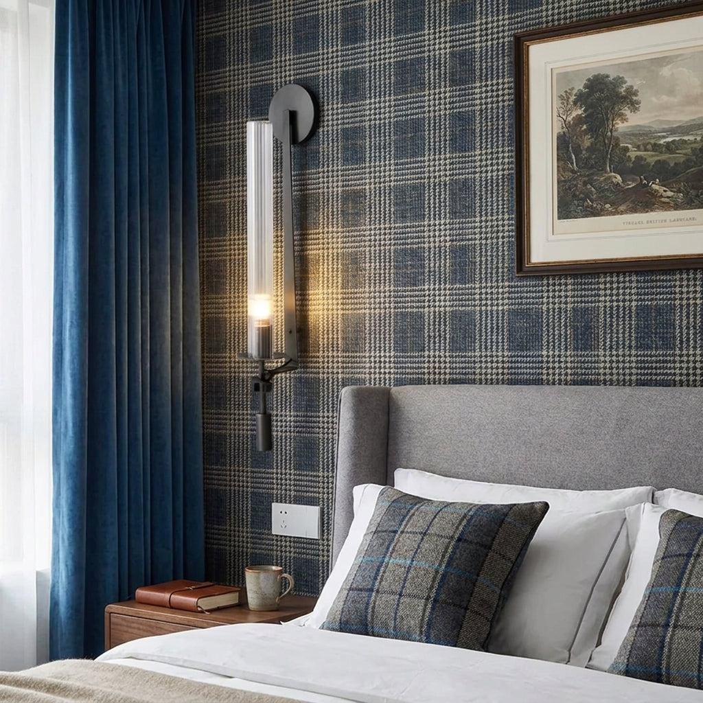 Xilpo Matte Black wall sconce on a teal wall next to a bed above a side table 