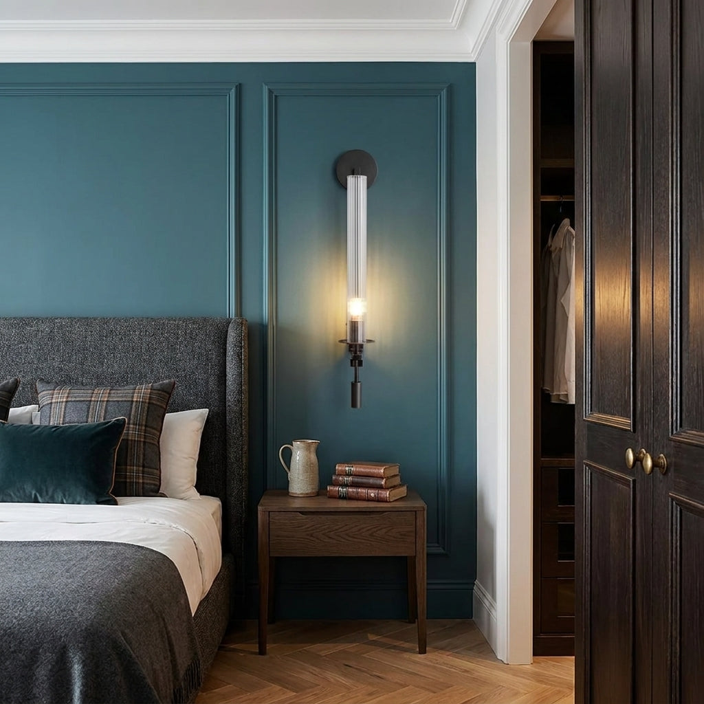 Xilpo Matte Black wall sconce beside a grey headboard mounted on a blue panelled wall