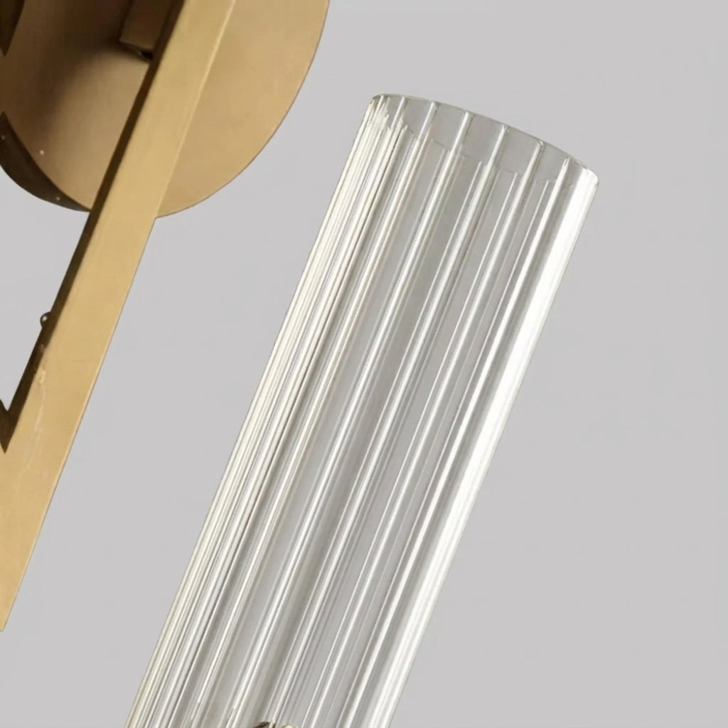 Close-up of the Xilpo Satin Gold wall sconce's fluted glass tube and iron frame