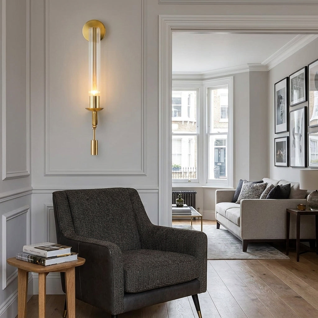 Xilpo wall sconce beside a dark armchair in front of tall curtained windows