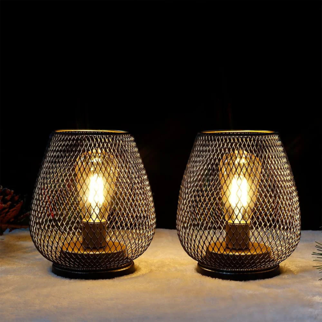 Two xolu industrial wire cage LED lanterns illuminating a dark room with a cosy, amber light