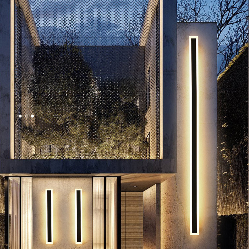 Multiple long xura linear exterior lights highlighting the modern architecture of a multi-story home at night