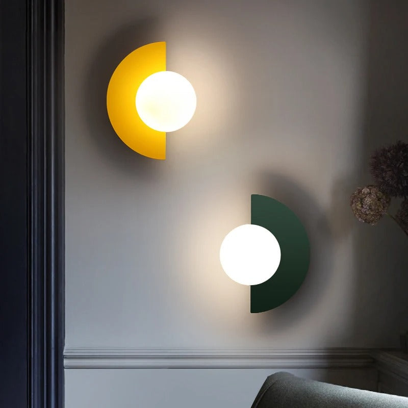 Yellow and green modern semi-circle wall lamps providing a playful pop of colour in a contemporary interior