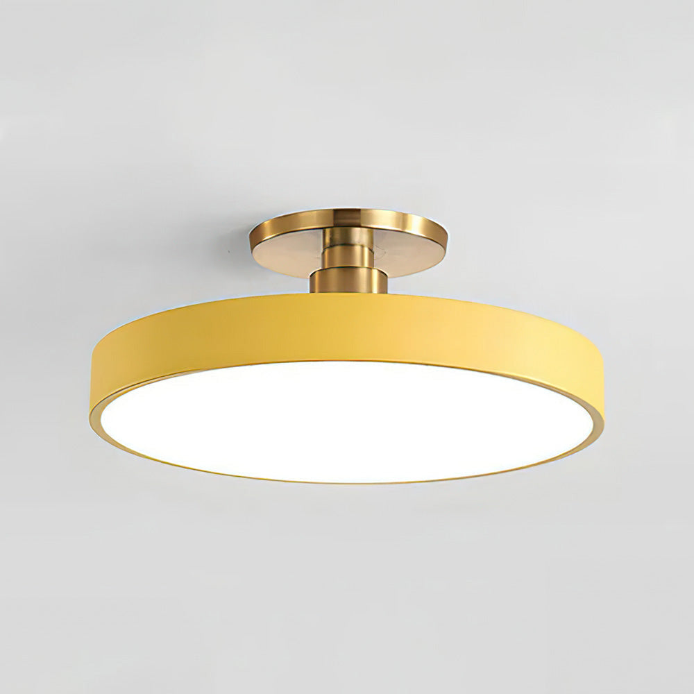 Vibrant yellow macaron drum ceiling lamp isolated on a light grey background