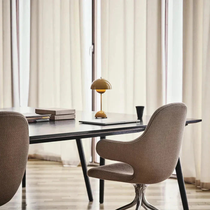 yellow minimalist wireless table lamp providing a soft, ambient glow in a modern dining or office space