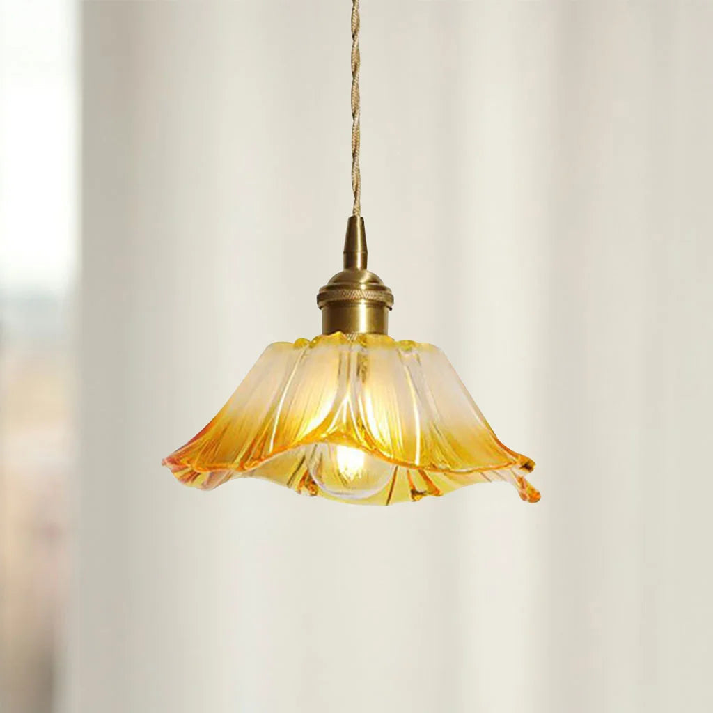 Yellow retro fluted dome pendant lamp glowing warmly against a plain wall
