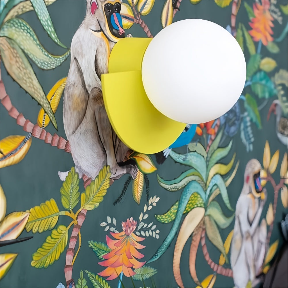 Bright yellow semi-circle wall sconce highlighting fun tropical botanical wallpaper