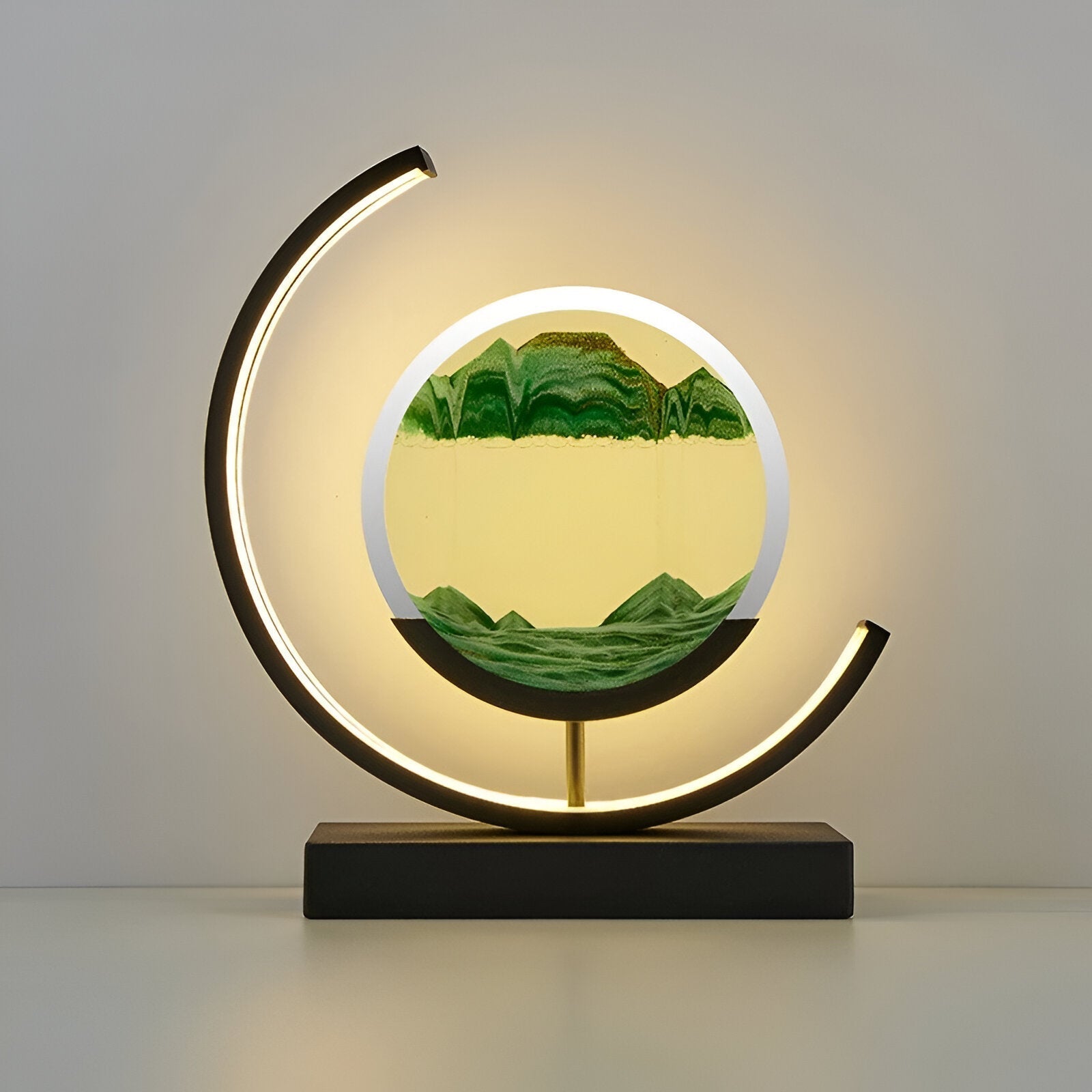 Black youj quicksand art desk lamp with vibrant green sand creating a flowing natural scene